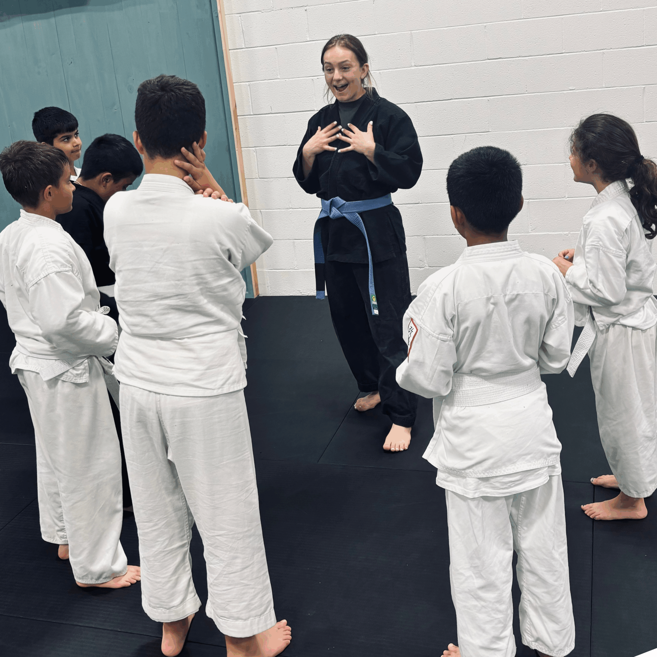 8 Group of karate students listening to their sensei in class.