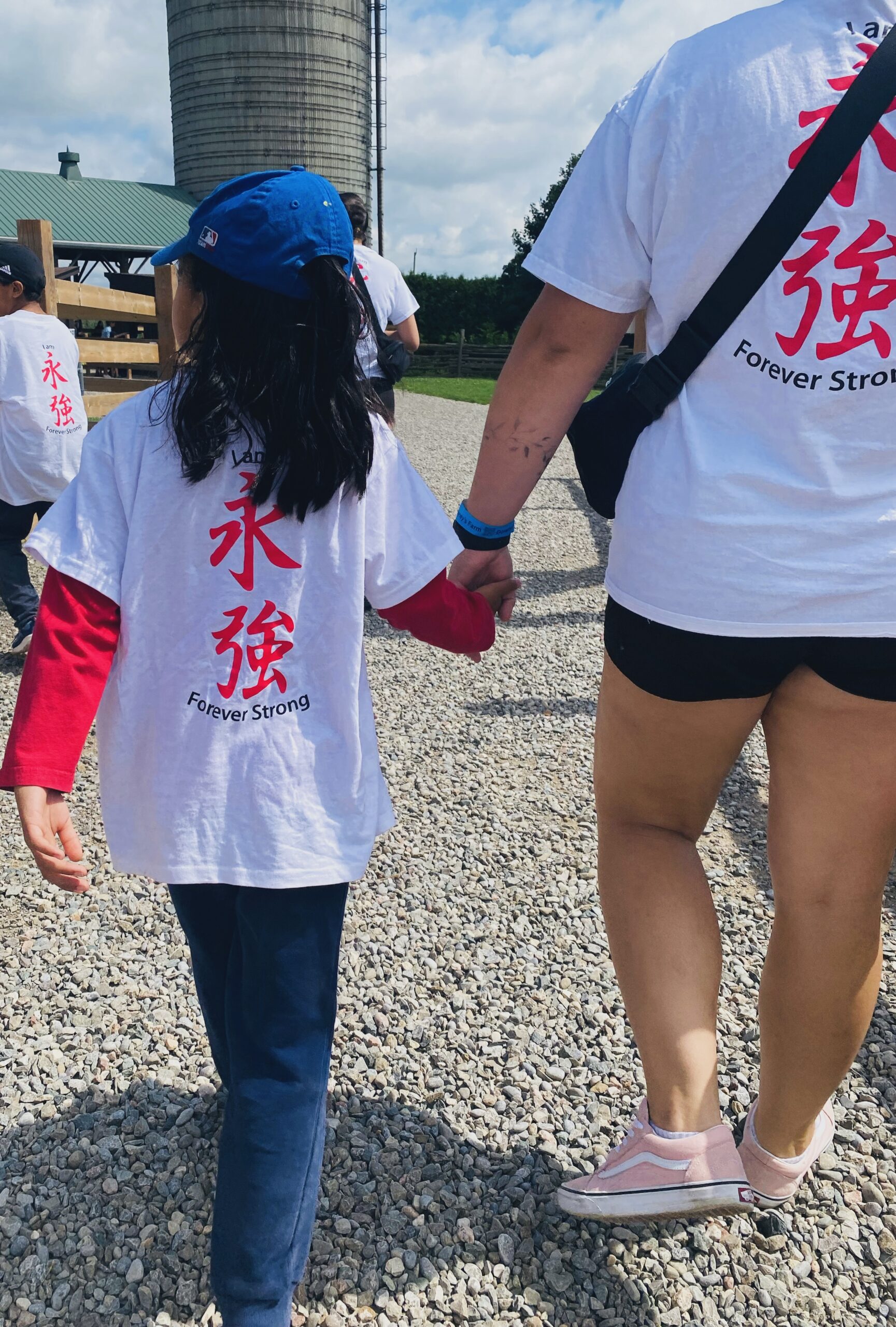 Karate Camp Day Trip Photo Staff walking with a camper holding hands